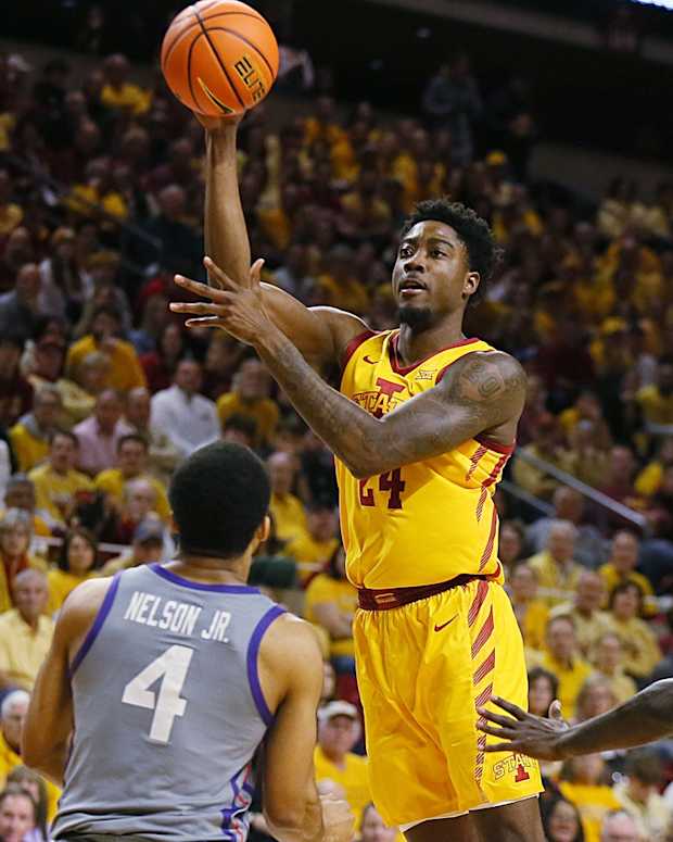 Iowa State Cyclones forward Hason Ward (24) passes the ball between TCU Horned Frogs guard Jameer Nelson Jr. (4) and forward Emanuel Miller (2) during the first half in the Big-12 conference showdown of a NCAA college basketball at Hilton Coliseum on Saturday, Feb. 10, 2024, in Ames, Iowa.